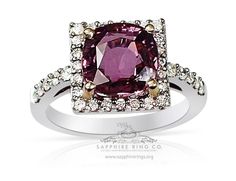 an engagement ring with a pink stone surrounded by diamonds