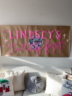 a sign that says lindsey's two best on the side of a wall above a couch