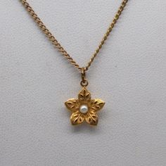 "Vintage Tiny Flower Pendant Necklace, Pretty Embossed Floral with Seed Pearl Center on Gold Tone Chain Measurement * 16 \" chain; 1/2\" pendant Condition * Very nice condition, gently used. Size: Womens 16\" Condition: Pre-Owned Good" Gold Flower Necklace With Vintage Charm, Vintage Necklace With Flower Pendant, Vintage Gold Necklaces With Flower Shape, Vintage Hallmarked Flower Pendant Necklace, Vintage Gold Flower Shaped Necklace, Vintage Flower Necklaces For Anniversary, Antique Hallmarked Flower Pendant Necklace, Antique Gold Flower Necklace, Vintage Flower Necklaces For Formal Occasions