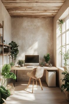 a home office with plants and a computer