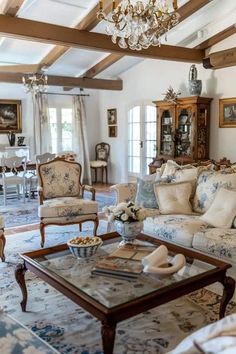 a living room filled with furniture and a chandelier