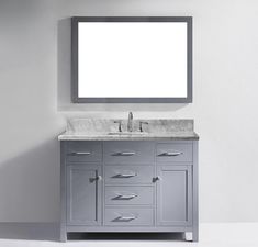 a bathroom vanity with a mirror above it and a white wall behind it, in an empty room