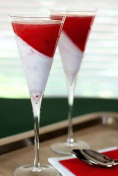 two glasses filled with red and white liquid