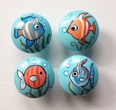 four painted balls with fish on them