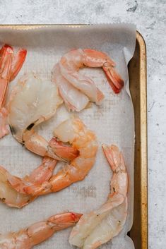 raw shrimp on a baking sheet ready to be cooked and put in the oven for cooking