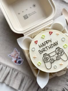 a birthday cake with the words happy birthday on it and a video game controller decoration