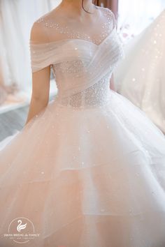 a woman in a white wedding dress is posing for the camera