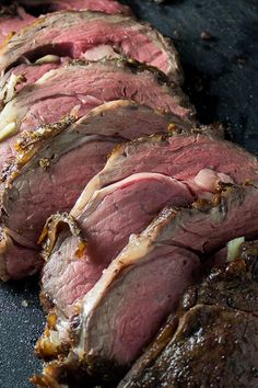 slices of roast beef on a grill with garlic