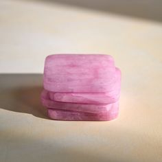 three pink soap bars stacked on top of each other