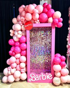 there is a pink and white photo frame made out of balloons with the word barbie on it