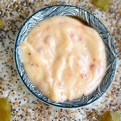 a bowl filled with some kind of food on top of a white and blue plate