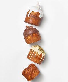 four different types of pastries on a white surface with one being drizzled with icing