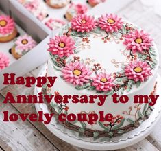 a happy anniversary to my lovely couple cake and cupcakes with pink flowers on them