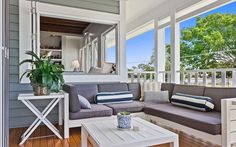 a living room filled with furniture and a large mirror