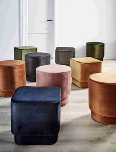 several different colored stools sitting on the floor