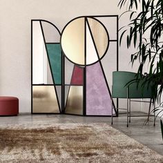 a living room with an area rug, chair and mirror on the wall in front of it