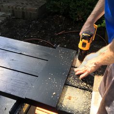 a man using a drill to cut wood