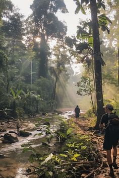 two people walking in the woods with backpacks