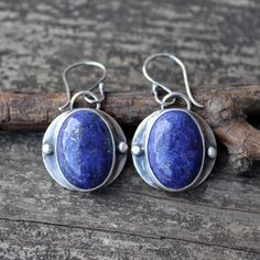 🌟PLEASE READ the following description before making your purchase.  Note measurements and size reference photos. Lapis lazuli sterling silver dangle earrings 13x18mm lapis lazuli is set in pure silver on a 19mm sterling disc dangling from comfortable argentium silver (hypoallergenic) ear wires. Medium weight dangles measuring a touch over 1 1/4" long Handmade Rustic Oval Jewelry, Rustic Sterling Silver Dangle Jewelry, Artisan Sterling Silver Earrings With Natural Stones, Rustic Blue Sterling Silver Jewelry, Rustic Sterling Silver Dangle Earrings, Rustic Sterling Silver Earrings, Lapis Earrings, Jewelry Sale, Silver Dangle Earrings