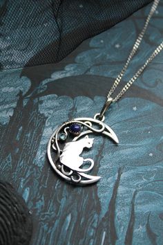 ITEM DESCRIPTION: The size of this moon pendant H 4 cm x W 3 cm. Weight - 4g. You can buy this necklace with a chain or without. Jewelry will come to you in a gift box - ready for gift giving. I made this moon phases necklace of sterling silver, Lapis lazuli, and topaz London. It looks like a real magic art. The handmade silver pendant with the cat will be a great gift for cat lovers. The parcel will be sent during 1-2 days after payment. Delivery usually takes 10-21 days. But in the period from Collectible Moon Charm Pendant Necklace, Collectible Round Pendant With Moon Charm, Cat Design Pendant Jewelry, Cat Design Round Pendant Jewelry Gift, Ursula Jewelry, Random Jewelry, Wire Animals, Cat And Moon, Moon Fashion