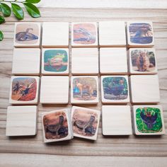 several coasters with pictures of animals on them sitting on top of a wooden table