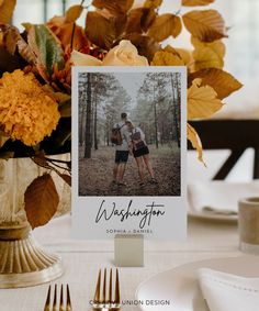 an image of two people hugging each other on a table with place cards and silverware