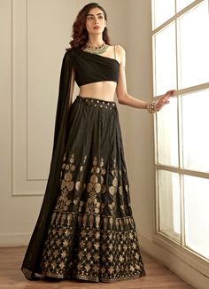 Features a jet black one shoulder blouse with a shoulder trail detail paired with black and block banarsi lehenga. Composition : Blouse- Crepe, lehenga - Banarasi Silk Care: Dry Clean Only and Vacuum Storage This product can be customised for sleeves, length of blouse and neckline Delivery : 4-6 weeks as the product is hand crafted. Check Size Guide or choose MySize for free customisation (All Sizes above XL can be made at 15% additional cost) For more information and sizes please contact fabili One Shoulder Lehenga, Studio Iris, Silk Skirt Outfit, Black Silk Skirt, Black Lehenga, Lehenga Blouse Designs, Fabric Skirt, Traditional Indian Dress