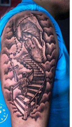 a man's arm with a tattoo on it and stairs going up to the sky