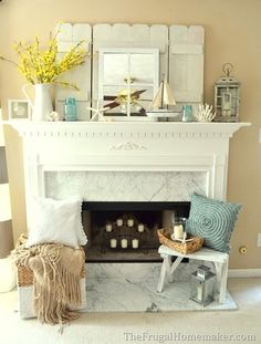 a living room filled with furniture and a fire place in front of a white fireplace