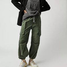 Style No. 79330031; Color Code: 037 Cool In Cargo, These Sporty Pants Are A True Timeless Staple. Fit: Mid-Rise, Tapered Fit And Classic Cargo Silhouette Features: Smocked Waistband With Drawstring Detail, Cargo Pockets Throughout, Banded Hemlines, Sleek Nylon Fabrication Why We <3 It: Just As Effortless As They Are Versatile, These Pants Have Endless Ways To Wear. Care/Import Machine Wash Cold Import Measurements For Size Small Waist: 30.5 In Hips: 42 In Rise: 12.25 In Inseam: 27.25 In 53% Nylo Fall Utility Parachute Pants With Tapered Leg, Utility Parachute Pants For Winter, Fall Cargo Parachute Pants With Tapered Leg, Fall Parachute Cargo Pants With Tapered Leg, Winter Utility Nylon Parachute Pants, Winter Utility Cargo Pants With Elastic Waistband, Winter Relaxed Fit Parachute Pants, Winter Parachute Pants With Relaxed Fit, Fall Nylon Bottoms With Cargo Pockets