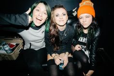 three young women sitting next to each other