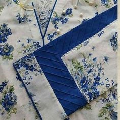 a blue and white table cloth with flowers on it