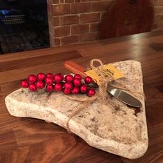 a knife and some red balls on a rock