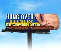 a billboard with the words hung over it's time for brownwood fitness in front of a blue sky