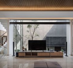 a living room with a large flat screen tv on top of a wooden entertainment center