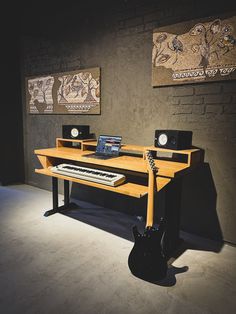 there is a desk with a keyboard on it and two speakers in front of it