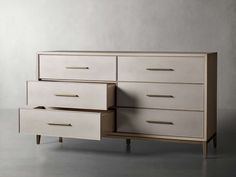 a white dresser sitting on top of a gray floor