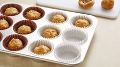 a muffin tin filled with peanut butter cupcakes next to a baking tray