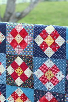 a close up of a quilt on a clothes line