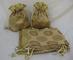 Gift bags for any occasion any time. Made from silk brocade fabric they are very bright and beautiful in look. Perfect for putting gift items like chocolates, dry fruits etc, during marriages, festivals and functions. Can be used as jewelry bags. These bags are in golden color. Bags have soft lining inside and are light weight. Size - 9.5 x 7.5 inches. For more such bags please visit- https://www.etsy.com/in-en/shop/vibrantscarves?ref=hdr_shop_menu&section_id=17341736 Gold Potli Bag With Pallu For Festivals, Diwali Gold Potli Bag With Pallu, Traditional Gold Potli Bag For Festivals, Gold Zari Work Potli Bag For Gift, Handmade Gold Bollywood Potli Bag, Handmade Gold Potli Bag For Celebration, Traditional Gold Bag For Festivals, Gold Handmade Potli Bag For Celebration, Gold Potli Bag For Festivals