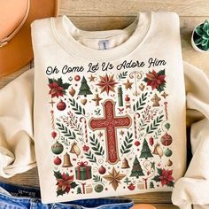 a white shirt with a cross and christmas decorations on it