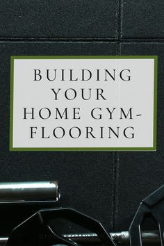 a sign that says building your home gym flooring on the side of a wall