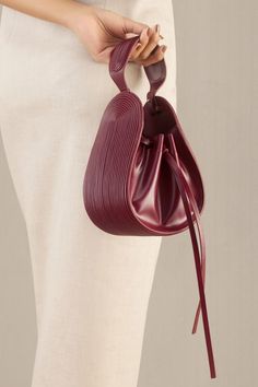 Wine corded bucket bag in faux leather with corded handle detail.
Composition: 100% PU/Faux Leather
Color: Wine
Other Details: 
Dimensions (in inches):
L x W x D: 6.5 x 3.5 x 7.5
Handle drop: 3.5
Closure: Adjustable drawcord - Aza Fashions Faux Leather Bag Diy, Classy Purses, Diy Leather Bag, Unique Handbags, Christmas Ornaments Diy, Handbag Essentials, Faux Leather Bag, Scrap Fabric, Buy Wine