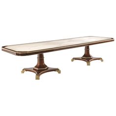 a long table with two pedestals on each side and a marble top in the middle