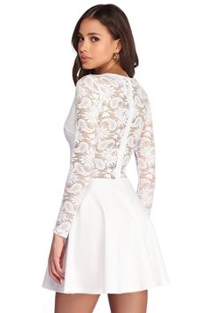 Our lace obsession continues with this beautiful ivory dress! Perfect for any occasion and any season. this dress features a sheer lace bodice with a V neckline. long fitted sleeves. and a discreet back zipper closure. A sweetheart lining and delicate scallop lace trim completes the bodice. The flattering skater skirt is composed of a crepe-like fabric with a moderate stretch. Skirt has no lining. Model is 5'9" with a 33" bust. 24" waist and 35.5" hips. She is wearing a size small. Feminine Lace Dress With Lace Sleeves For Date Night, White Long Sleeve Lace Dress With Scalloped Lace, Fitted Long Sleeve Lace Dress With Lace Back, White Lace Dress With Back Zipper, Feminine Long Sleeve Dress With Lace Bodice, Long Sleeve Lace Back Party Dress, Long Sleeve Lace Back Dress For Party, Elegant Long Sleeve Dress With Lace Back, Long Sleeve Lace Dress With Lace Back For Party