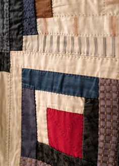 a close up view of a quilt with many different colors and shapes on it's sides