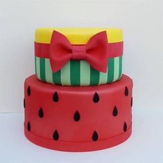 three tiered cake decorated with watermelon slices and a bow