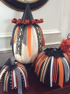 three decorative pumpkins sitting on top of a table