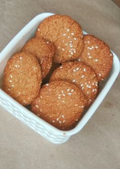 a white bowl filled with cookies on top of a table