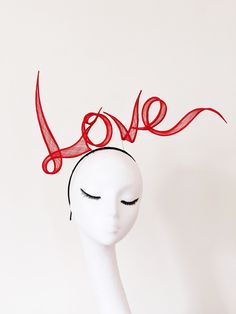 "No more availability in June 2023. Earliest dispatch 4th July 2023. thanks  No more availability in June 2023. Earliest dispatch 4th July 2023. thanks No more made to order available for Royal Ascot. Love is in the air!  Wear Your Heart On Your Head. Recently the Love headband is featured in editorial of UNBLOCKMAGAZINE \"LOVE ISSUE\". Hand rolled sinamay letters slogan in words or names, flowing on top of the headband, delicately connected with wires, with intricate craft skills and painstaking patience. The picture shows as LOVE for one words.  Customised names or words in special colours are Made to order. Price according the number of characters and size. Bigger or more words are more expensive.  Please contact info@yuanli.london for price and details. all hand made inside out  Materi Red Mini Hat For Christmas Party, Red Summer Headband Gift, Red Summer Headband As A Gift, Red Headpieces For Summer Gifts, Red Headpieces Suitable For Summer Gifts, Red Summer Headband For Gift, Red Headpieces As Summer Gifts, Red Christmas Party Headpiece, Red Mini Hat With Headband